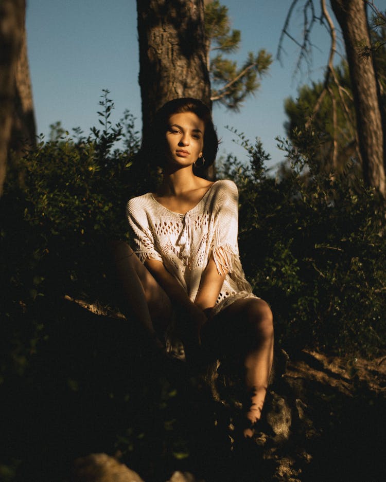 Woman Sitting Near Tree In Summer Forest