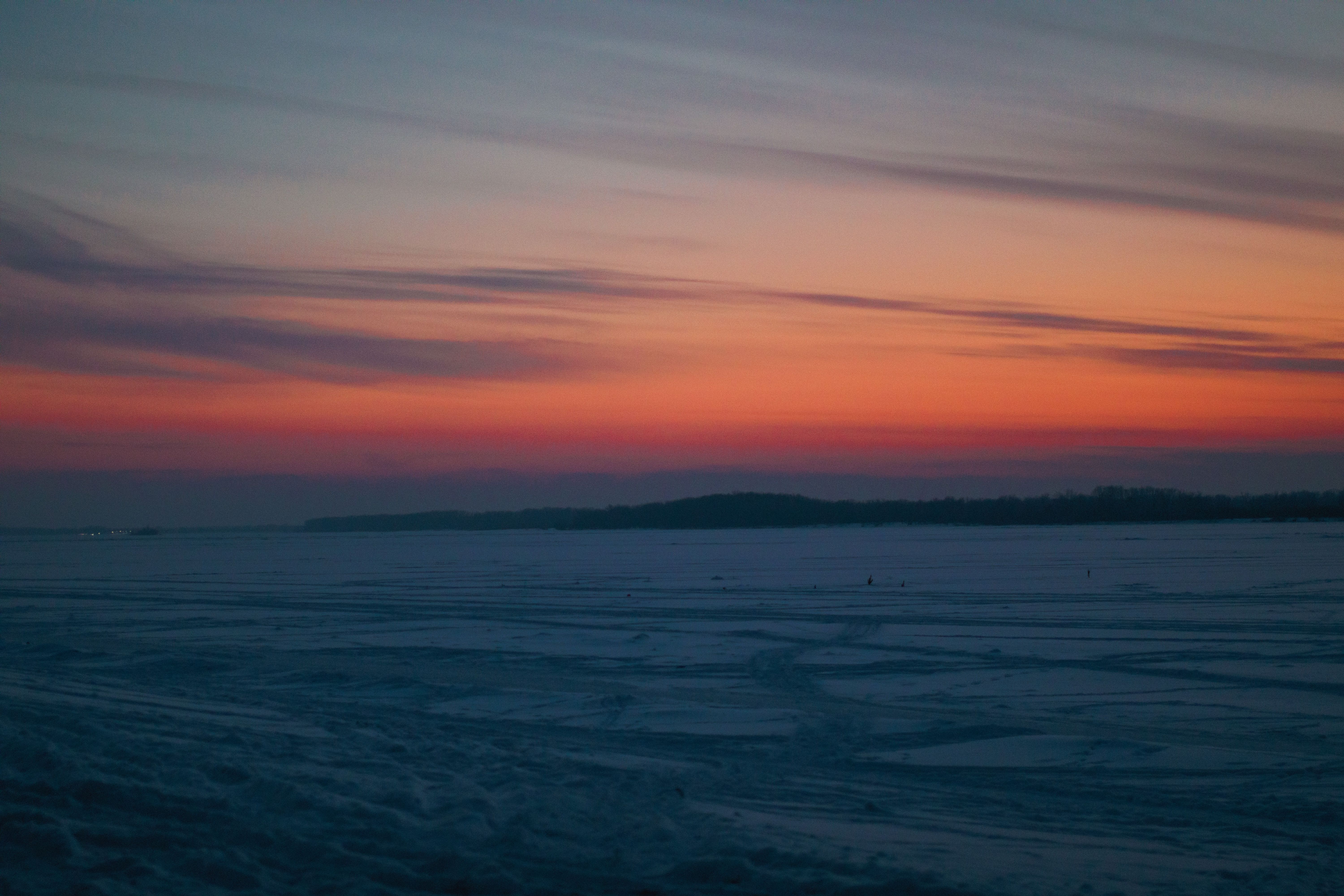 Stunning Winter Sunset Over Frozen Lake · Free Stock Photo