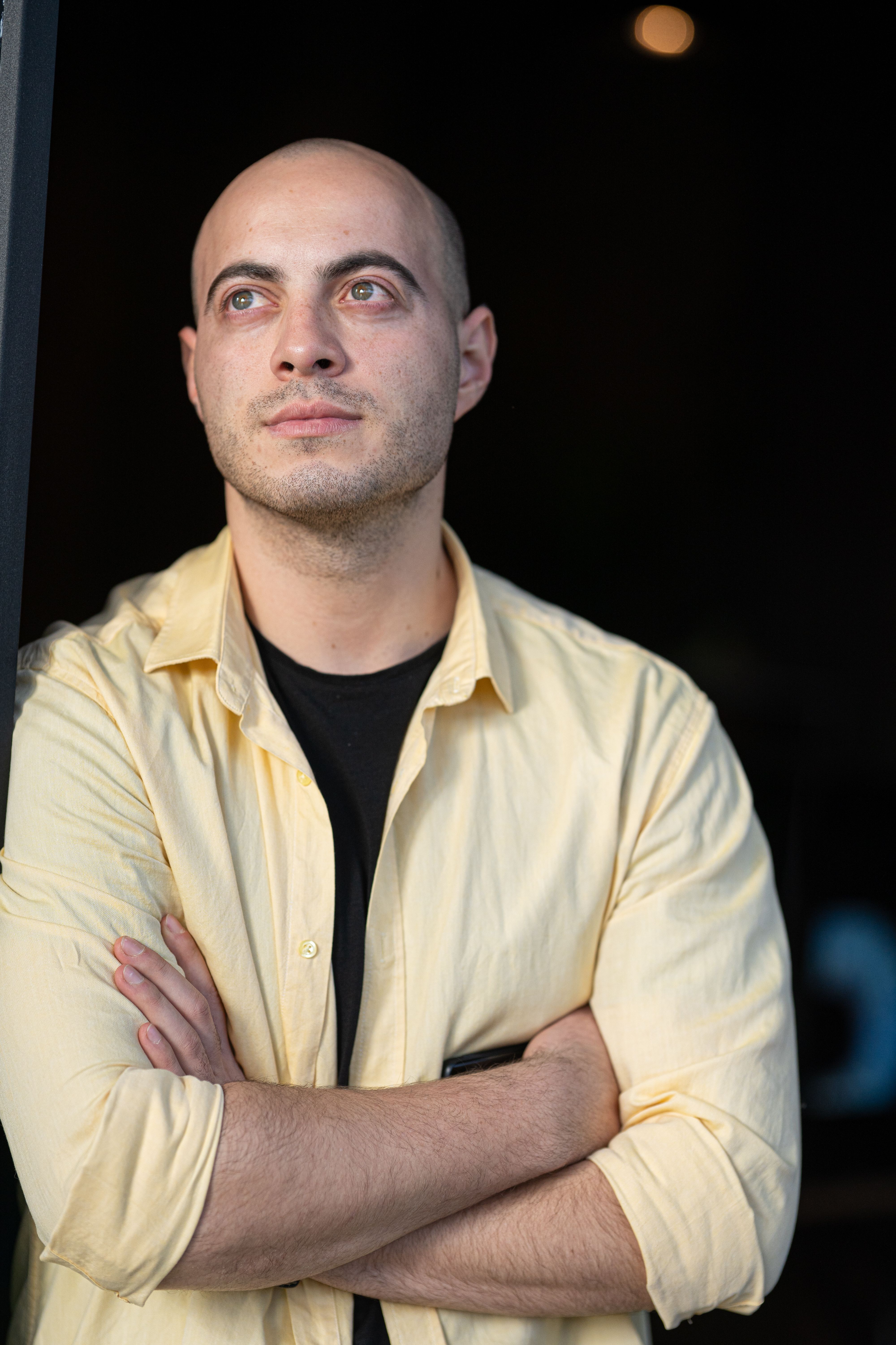 bald-man-standing-with-his-arms-crossed-free-stock-photo