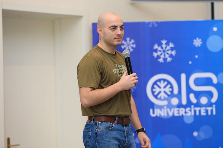 Young Man Giving A Speech During An Event At A University 