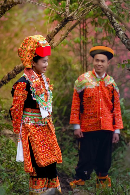 Woman and Man Posing in Traditional Clothing