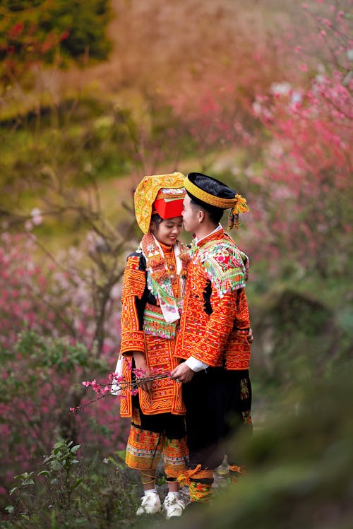 Woman and Man in Traditional Colorful Clothing 