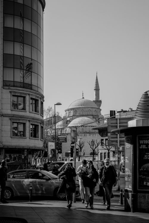 Free Black and white street view in Istanbul showing a mosque and bustling pedestrians. Stock Photo
