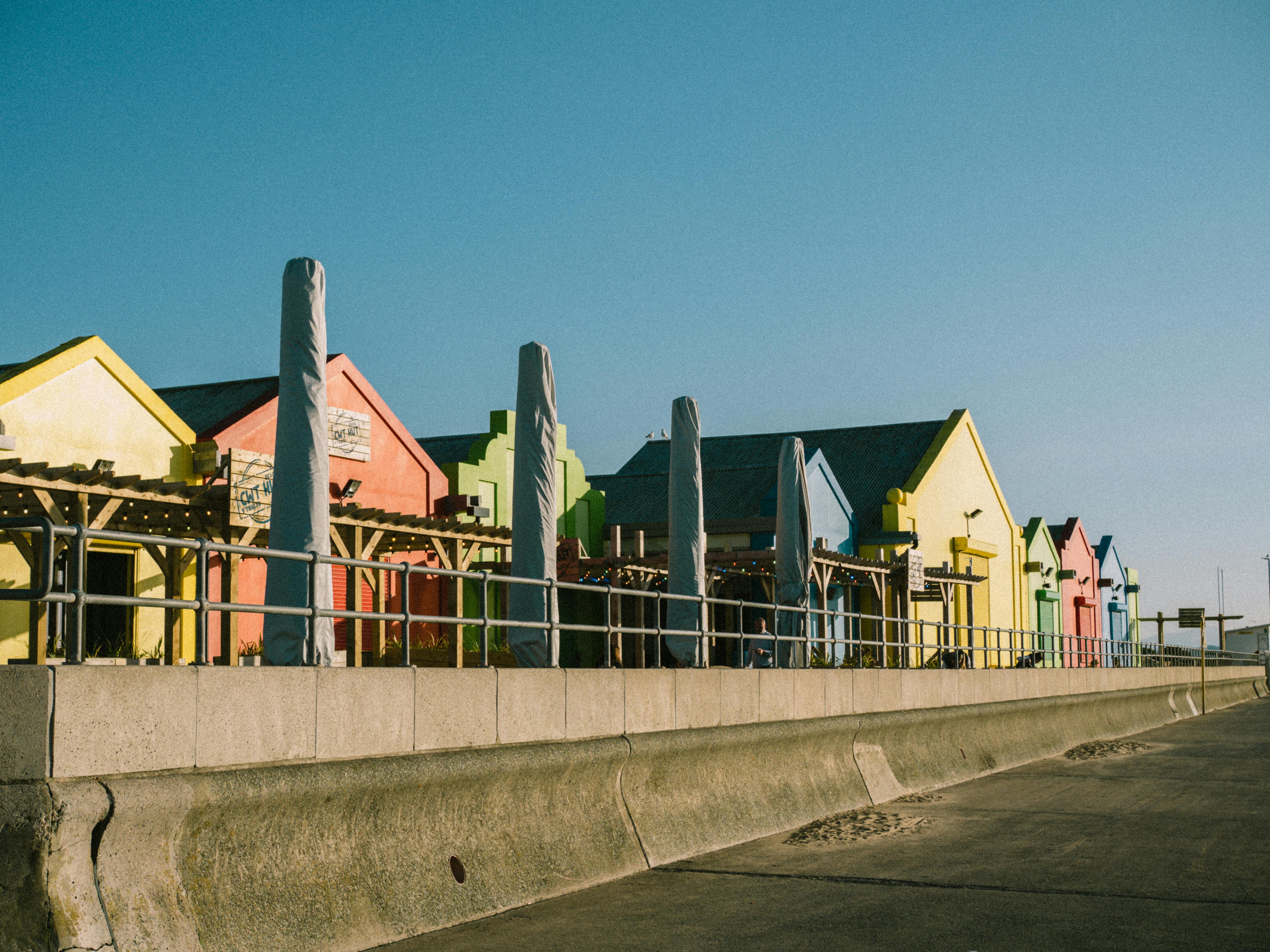 Vibrant row of colorful houses on a sunny waterfront promenade, perfect for travel and architecture themes.