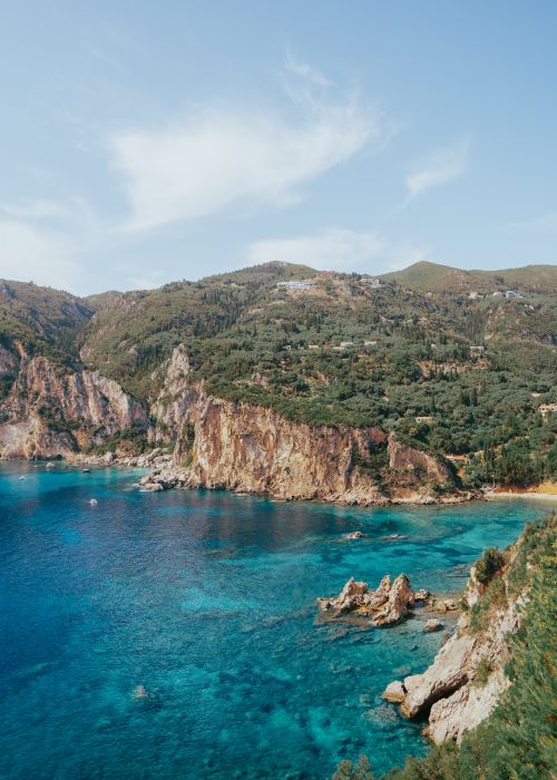 Free Discover the stunning cliffs and turquoise waters of Kerkyra's coastline in this vibrant summer landscape. Stock Photo