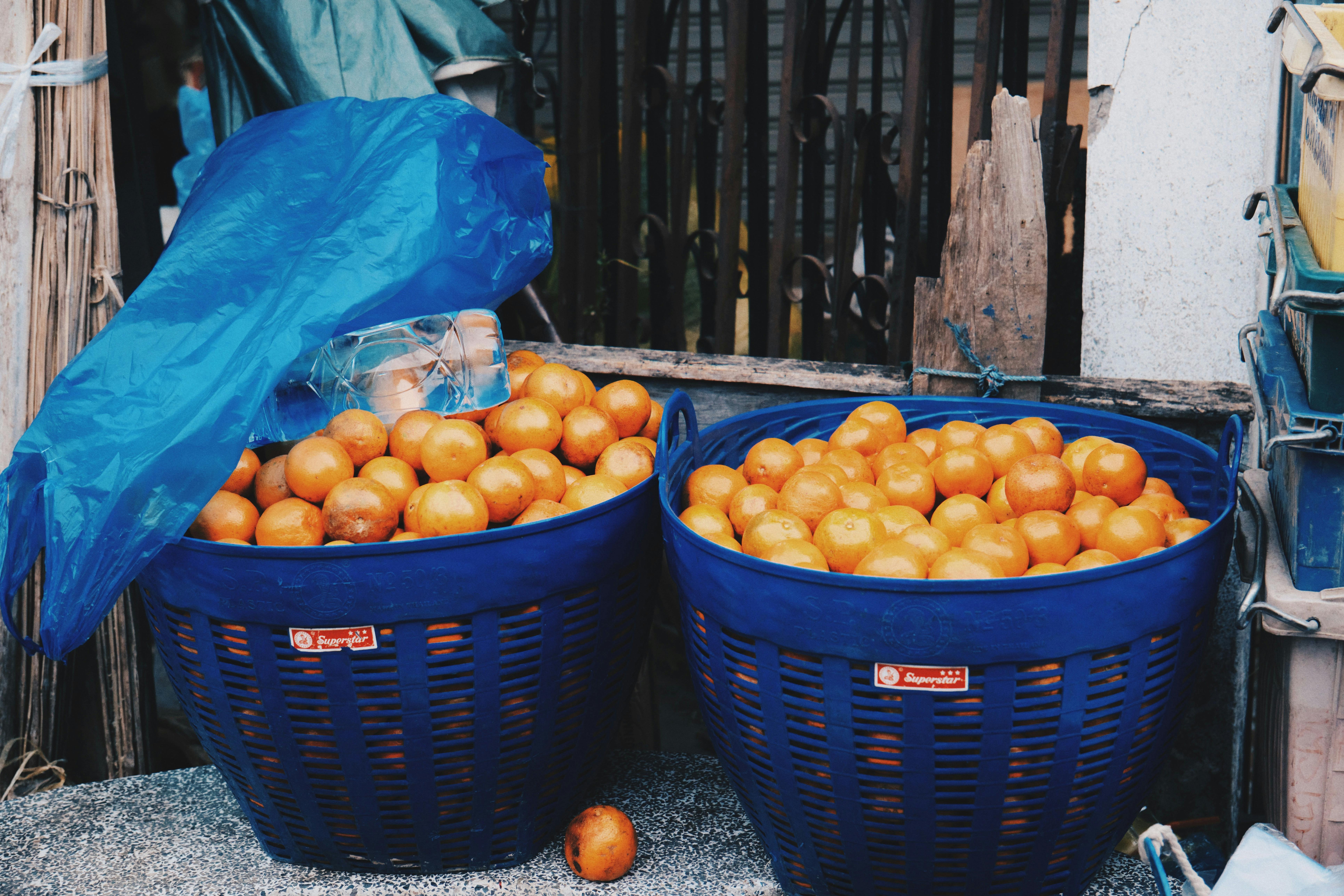 blue baskets of oranges