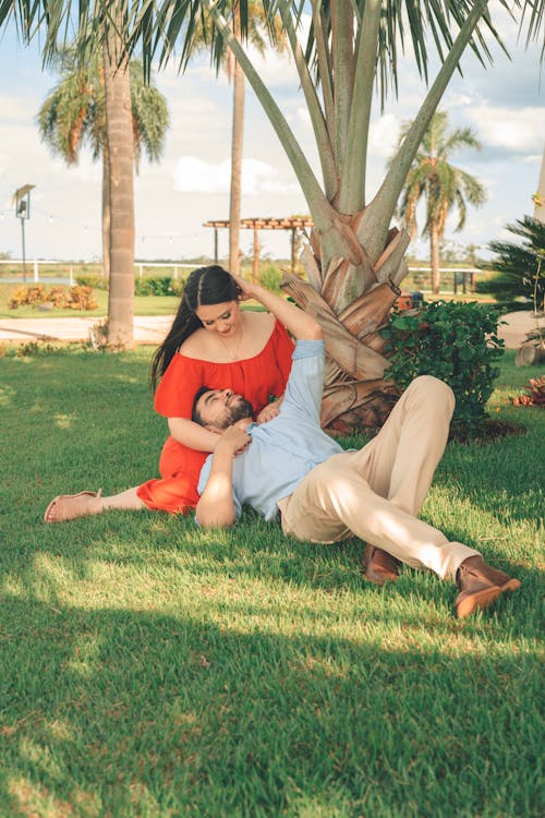 Free Couple Sitting and Lying Down on Grass Stock Photo