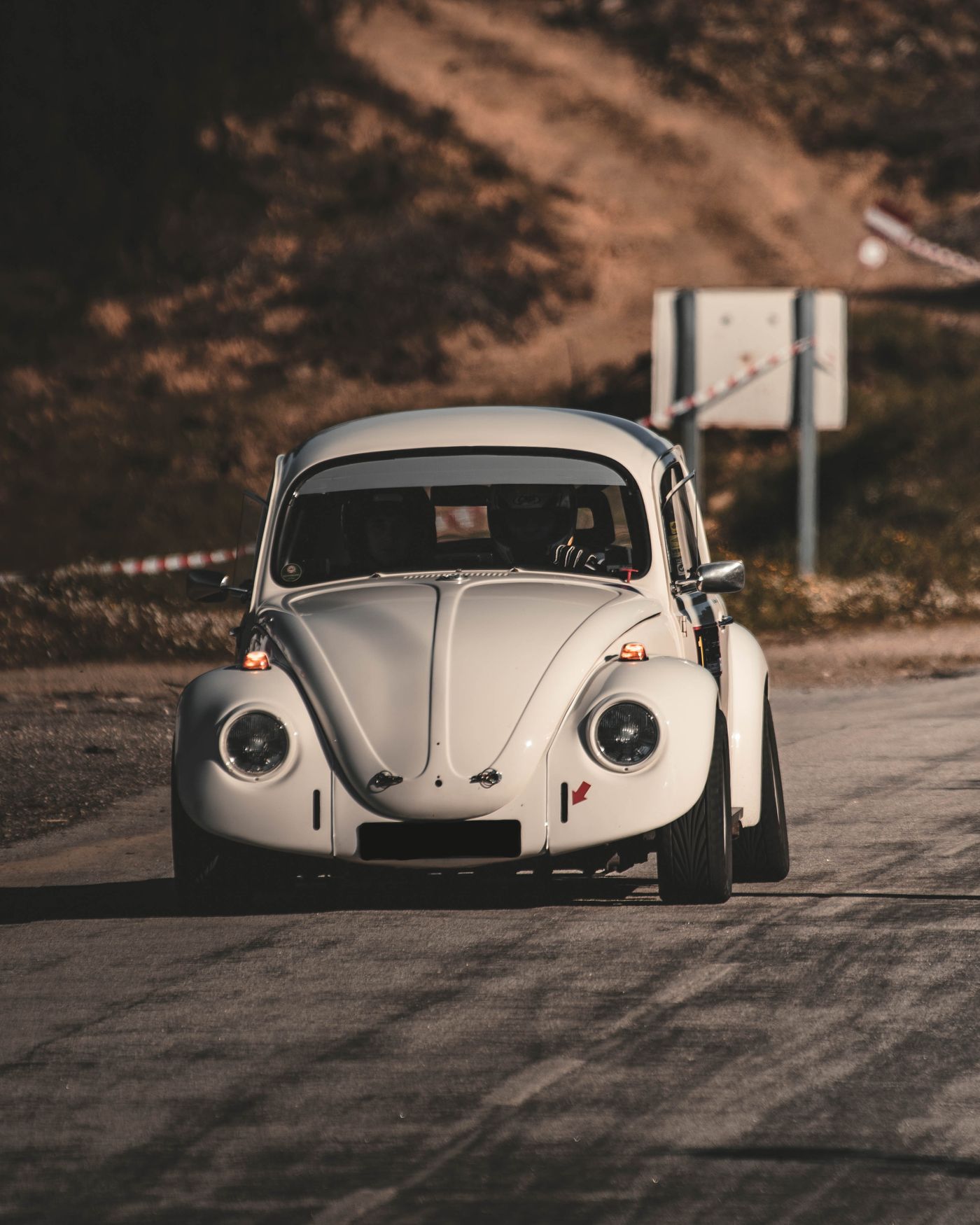 White vintage automobile on a sunlit road