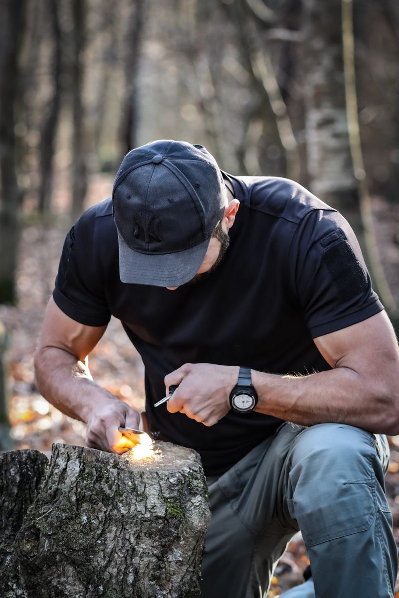 Hands practicing fire starting with flint