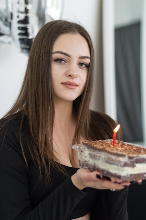 Free Young Brunette Holding a Small Birthday Cake  Stock Photo