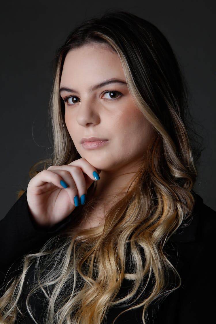 Portrait Of Woman With Nails Painted Blue