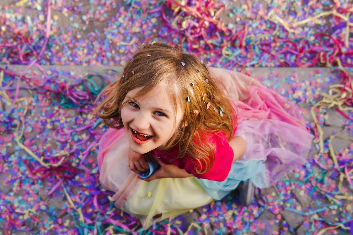 A Girl Surrounded by Confetti · Free Stock Photo