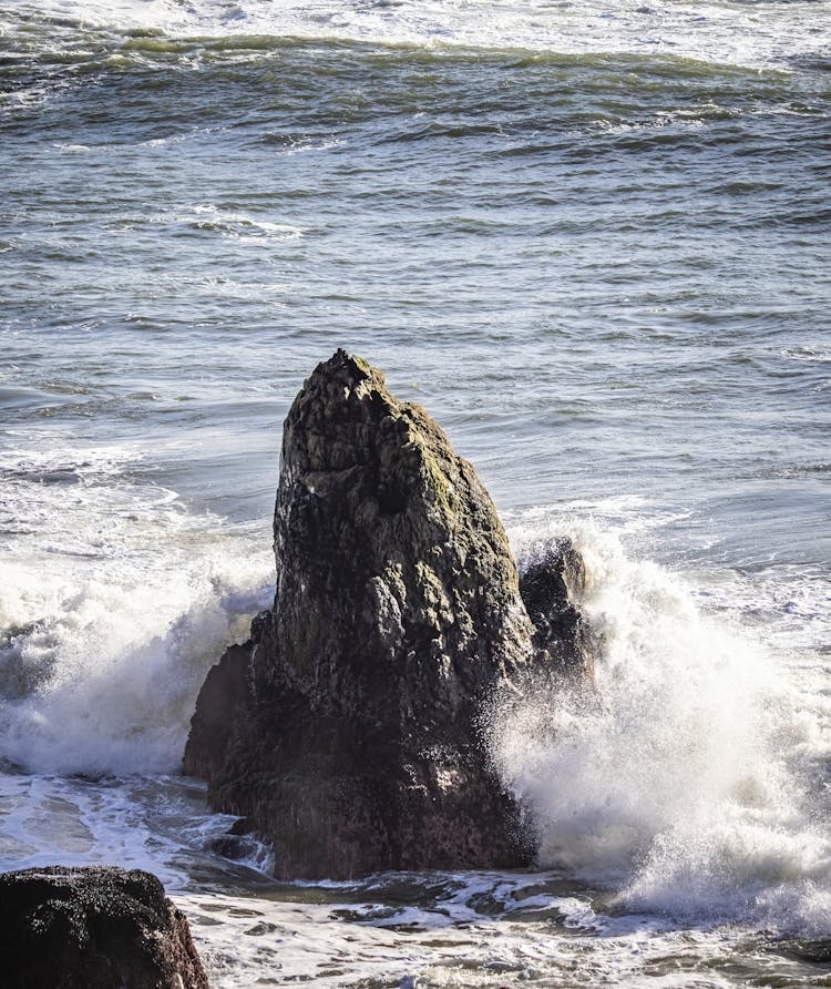 Waves Crashing On Rock By Shore