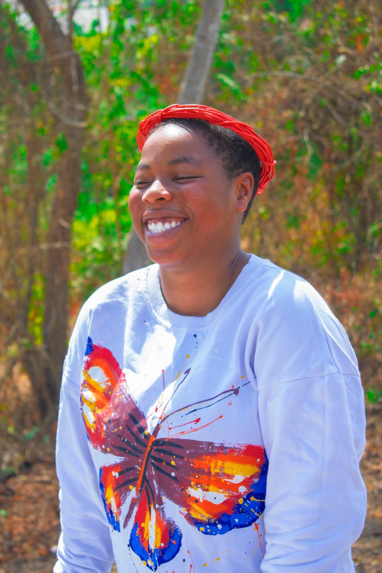 Smiling Woman With Butterfly On Pullover