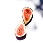 Two fig halves on a bright white surface, photo by Studio Naae on Pexels