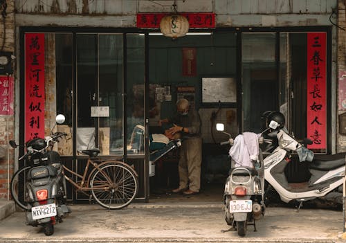 Scooters Parked in front of a Store in City 