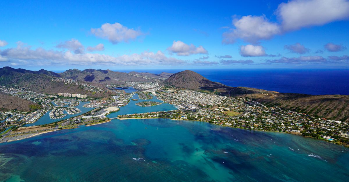 Photo by Cyrill Stunning aerial view of Honolulu, Hawaii, showcasing the coastline and Pacific Ocean.