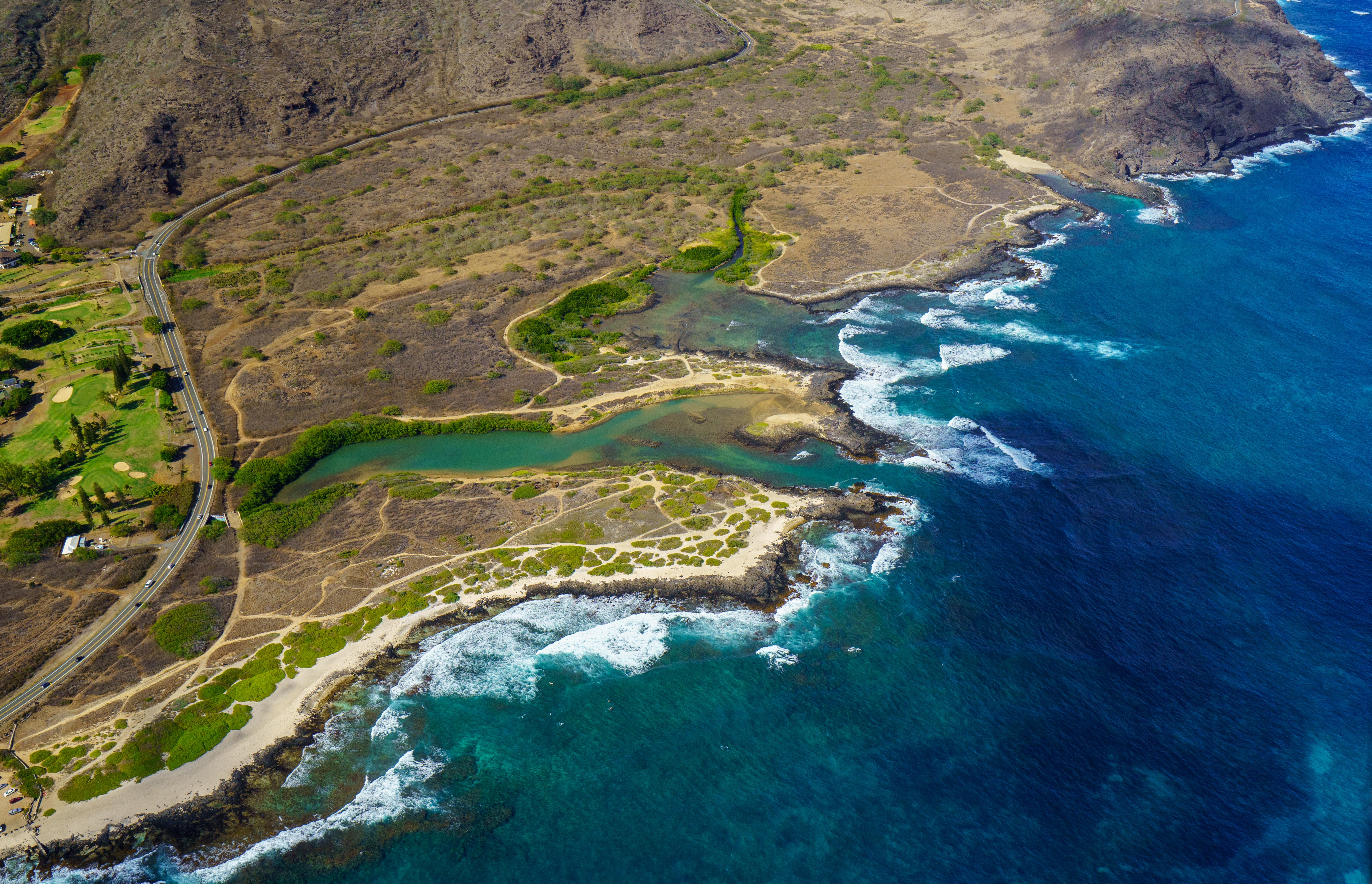 Breathtaking Waterfalls of West Maui and Molokai Helicopter Tour Review: An Unforgettable 50-Minute Adventure Review 2026 - Stunning aerial shot of a Hawaiian beach with clear blue waters and rugged terrain, perfect for travel and nature enthusiasts.