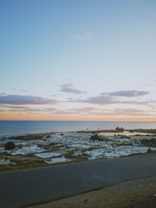 Free Breathtaking view of a coastal landscape at sunset with a clear blue sky and clouds. Stock Photo