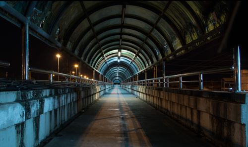 Free Captivating tunnel scene at night with urban lights casting shadows, creating an atmospheric passageway. Stock Photo