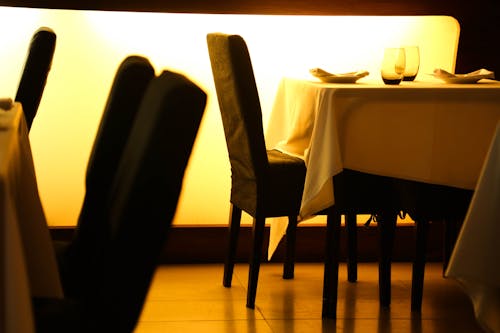 Beige Table Cloth Beside Black Padded Chair