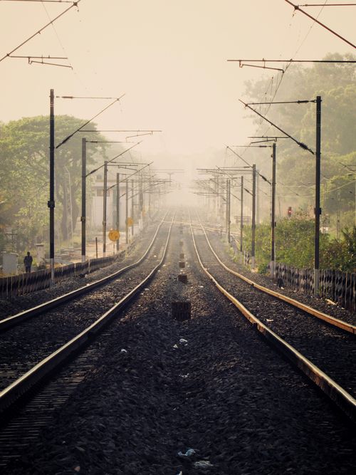 Free Symmetrical view of railway tracks vanishing into mist in Bengaluru. Stock Photo