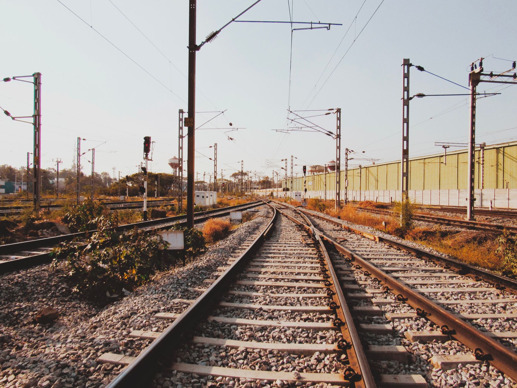 Explore the intricate railway tracks in Bengaluru, India under a clear blue sky.