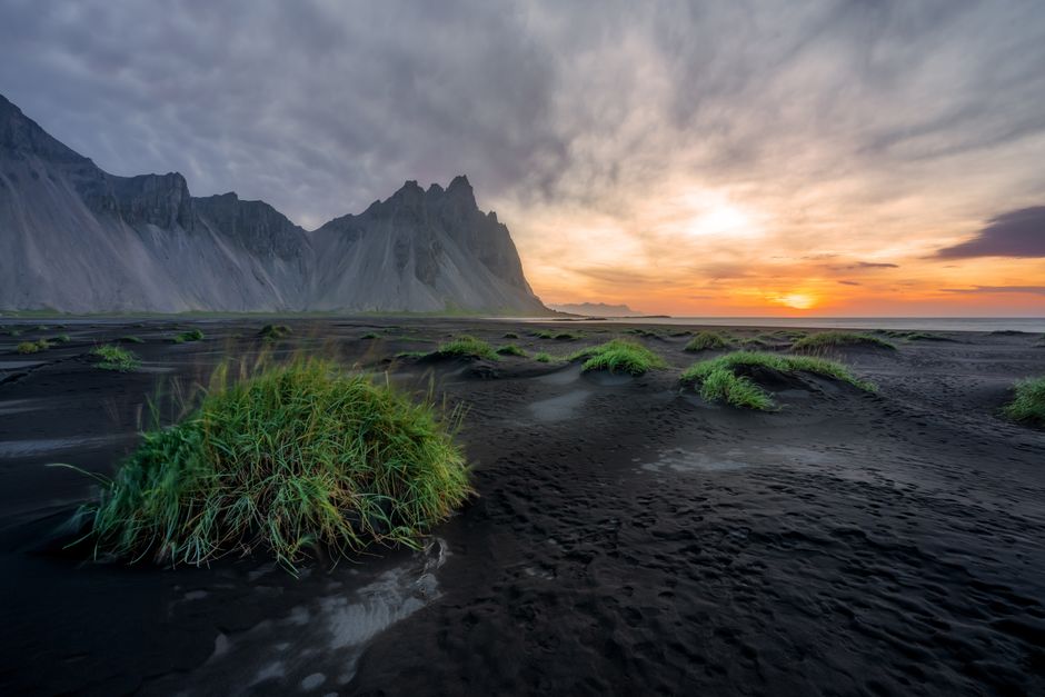 Majestic Vestrahorn Mountain in Iceland with black sand beach at sunset.