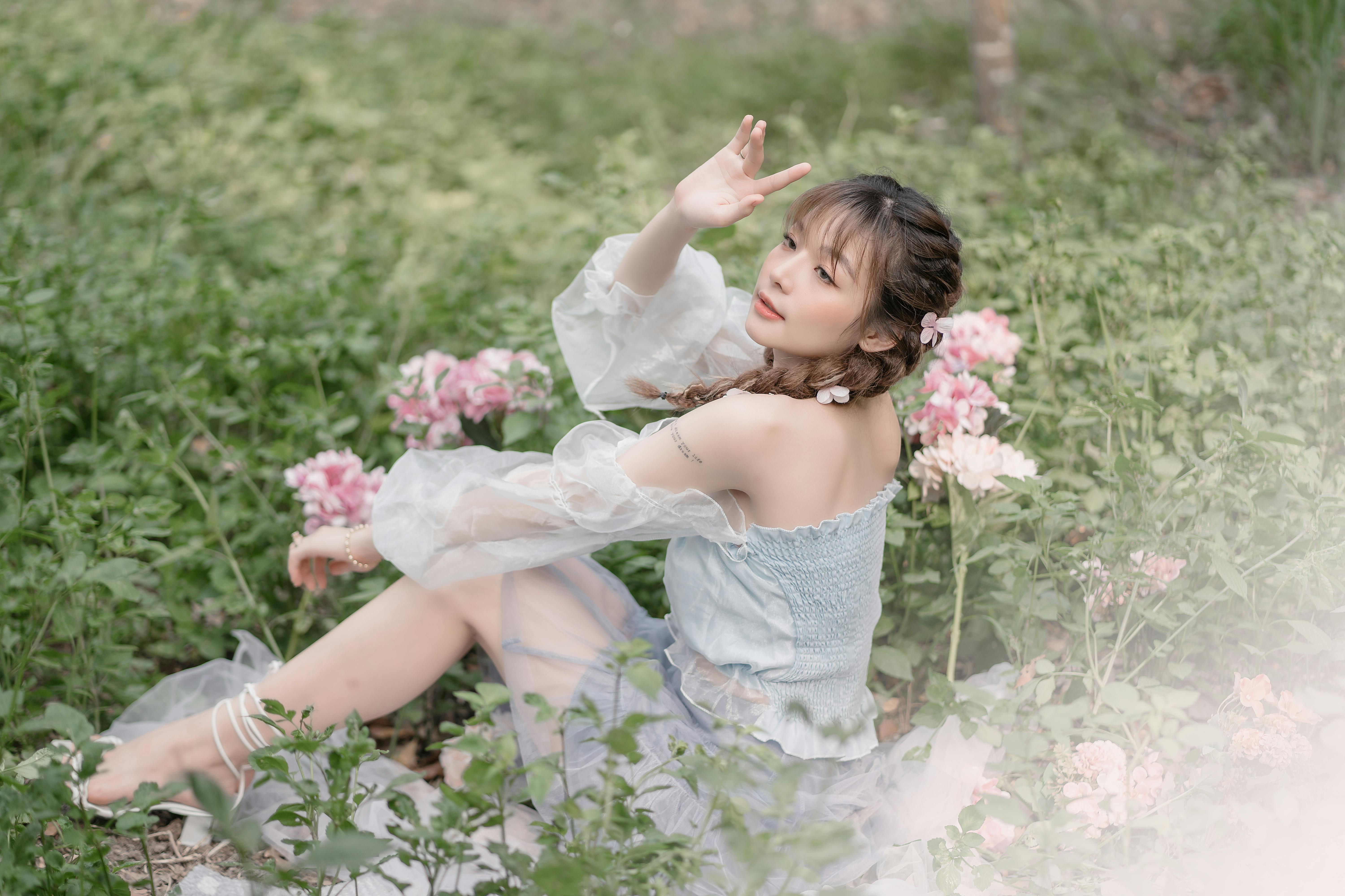 Adorable girl with basket flowers poses in a field Stock Photo | Adobe Stock