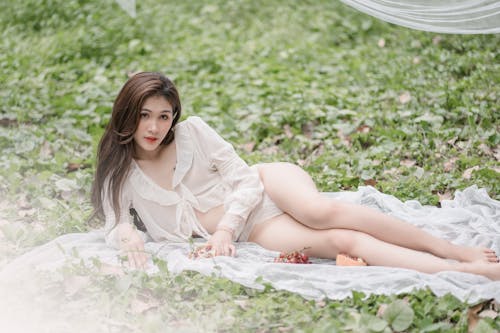 Woman Lying Down on Grass and Posing