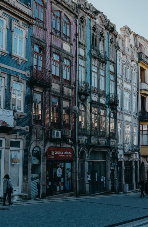 Free A vibrant scene of colorful historic townhouses lining an urban street. Stock Photo