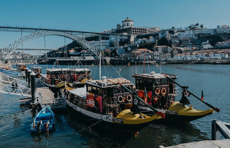 View Of Boats On The River Douro And Dom Luis I Bridge In The Background, Porto, Portugal 