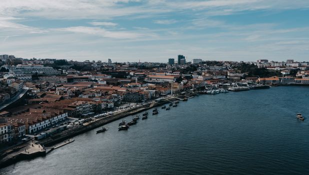 A beautiful aerial view of a coastal city with a vibrant skyline and calm waters.