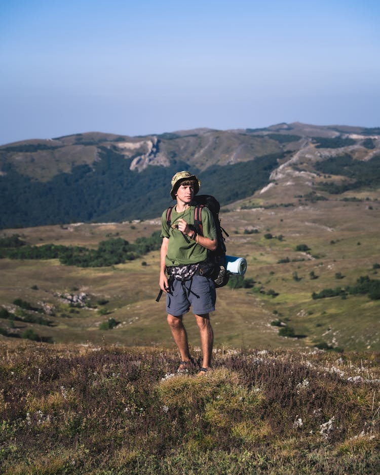 Backpacker Hiking In Mountains