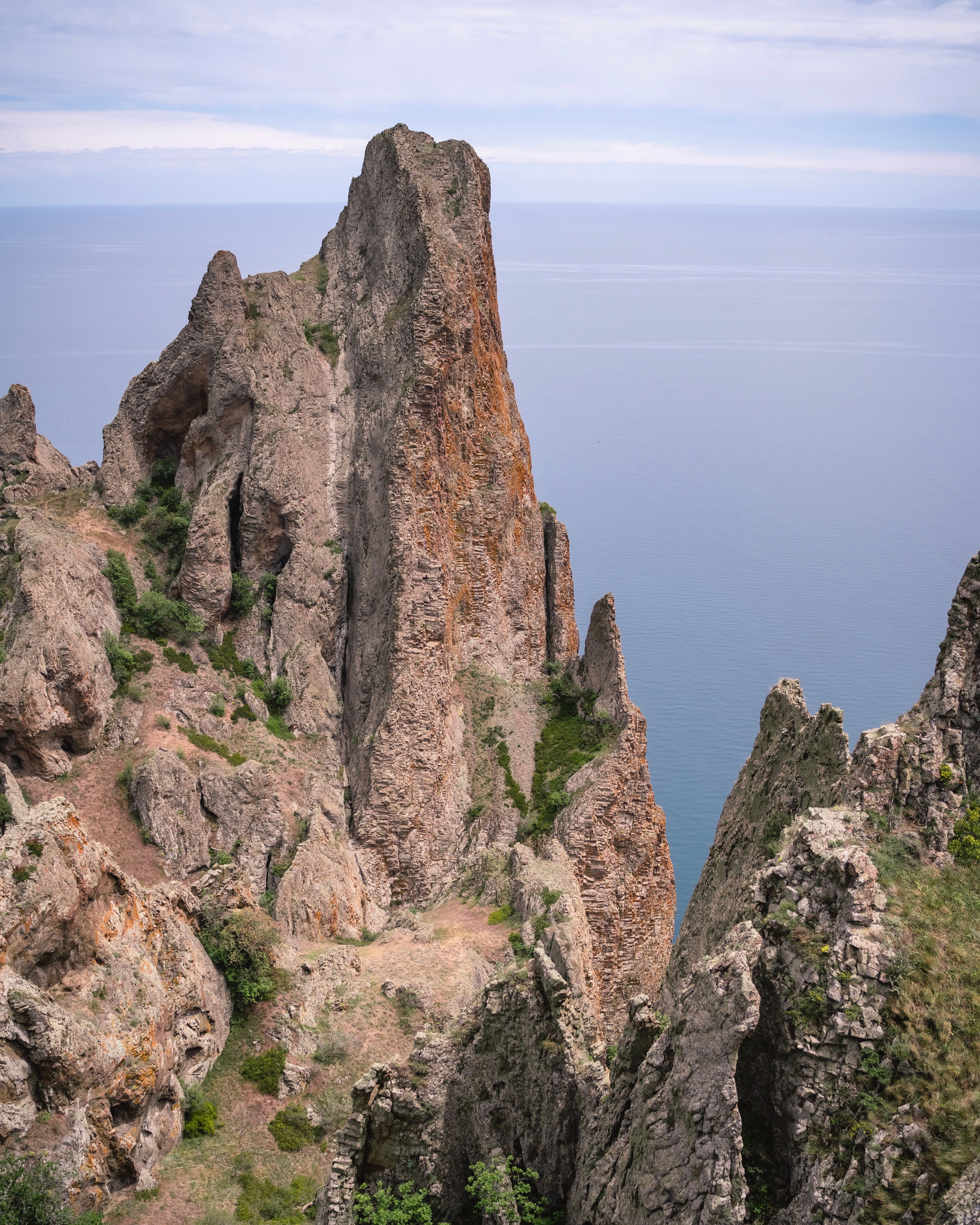 Stunning cliff rock formations overlooking the sea at daytime.
