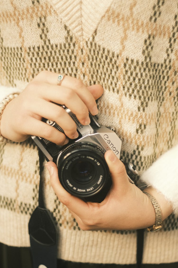 Hands Of A Woman Holding A Camera