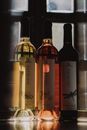 Three wine bottles elegantly displayed with reflections, capturing the essence of indulgence.