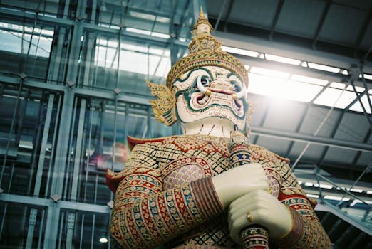 Colorful guardian statue at Bangkok airport, showcasing Thai cultural art.