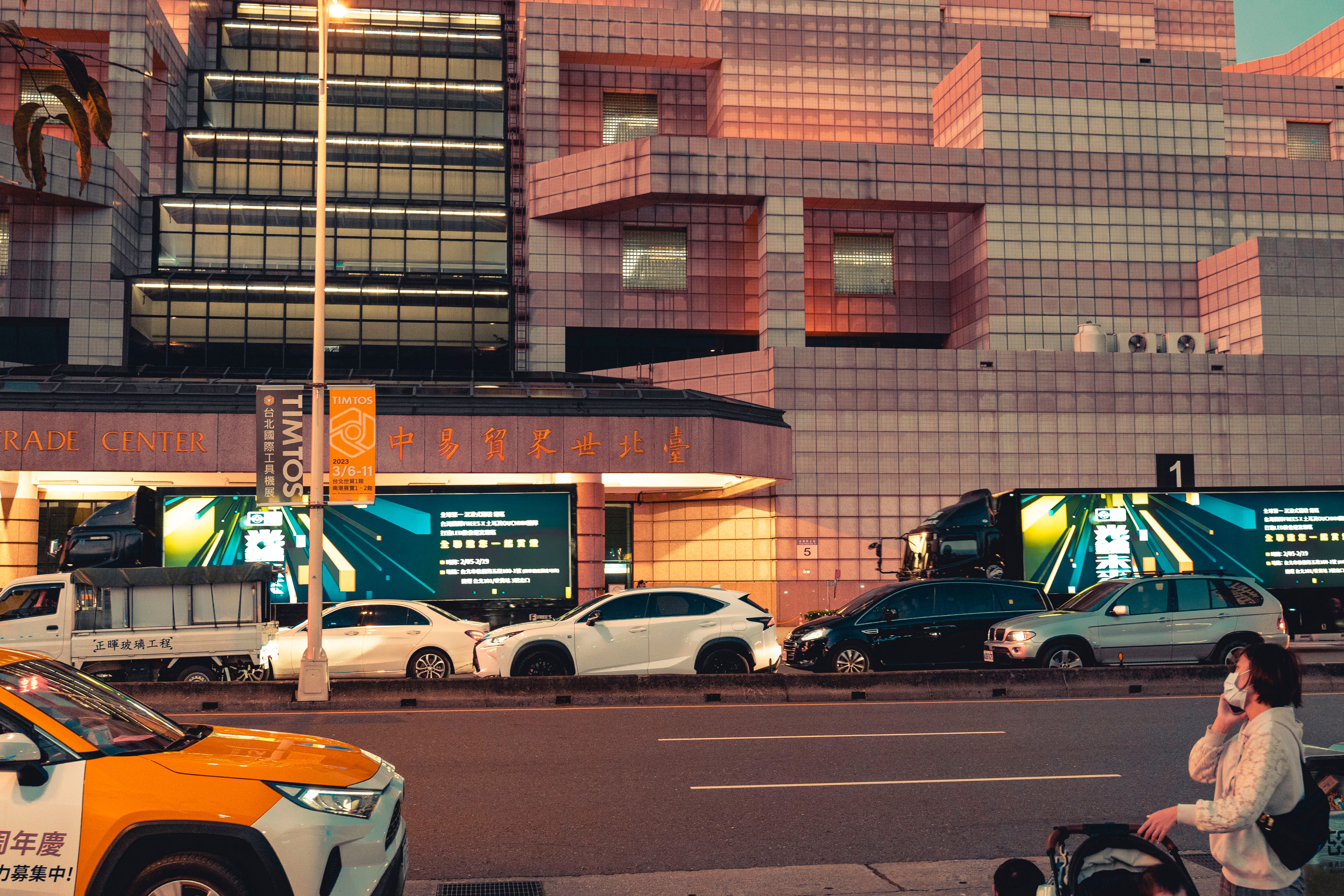 A Busy City Street and Facade of a Modern Building · Free Stock Photo