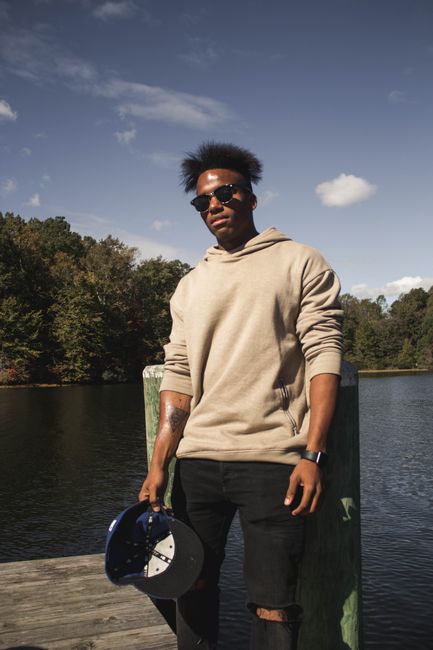 Portrait of a man enjoying leisure on a lakeside dock in Williamsburg, Virginia.