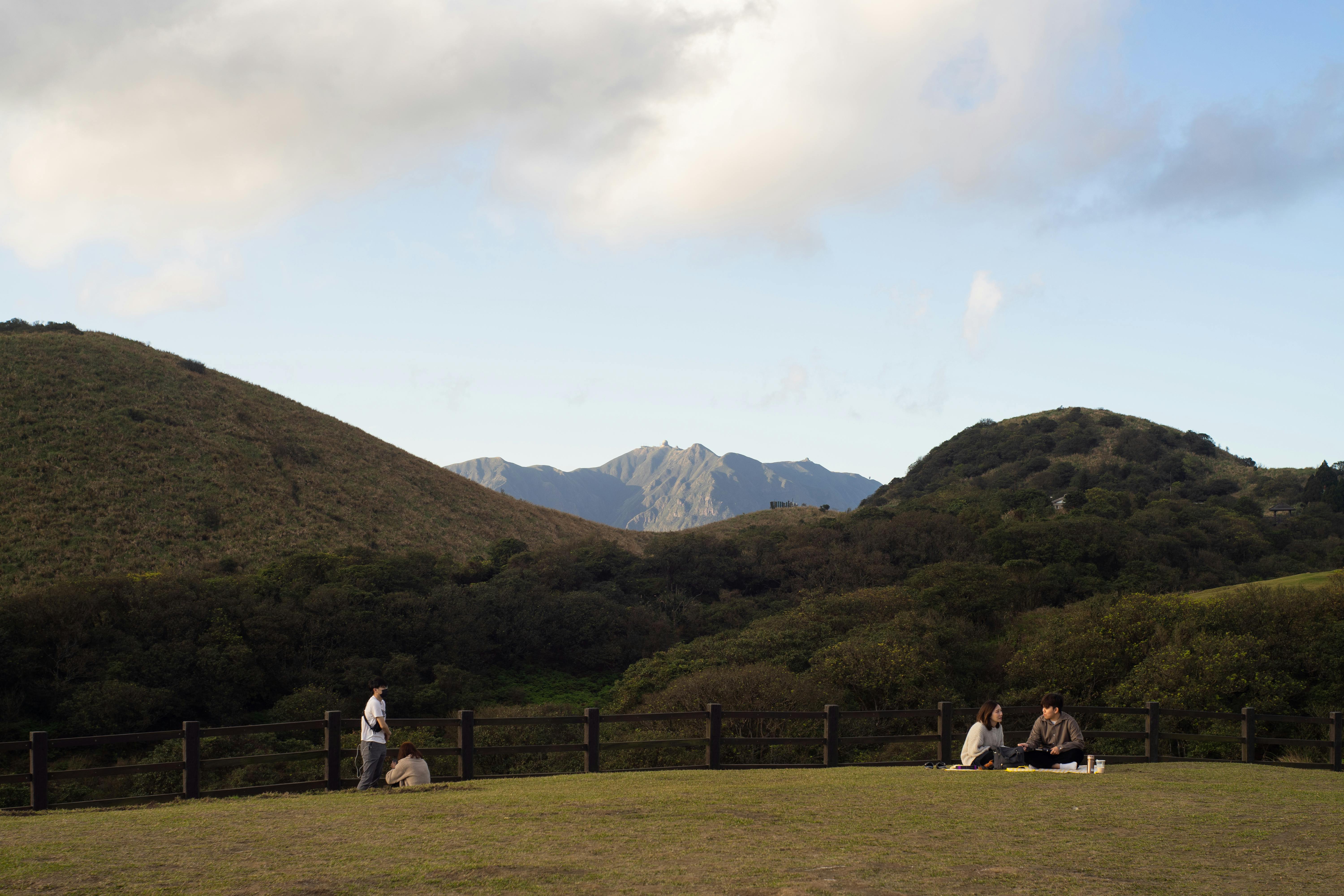 Enjoying a peaceful picnic with scenic mountain views in Yangmingshan National Park, Taipei.