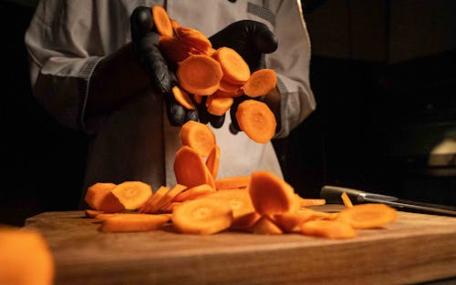 Close-up of a Chef Holding a Chopped Carrot 