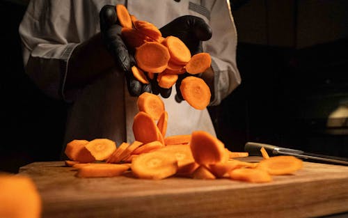 Close-up of a Chef Holding a Chopped Carrot 