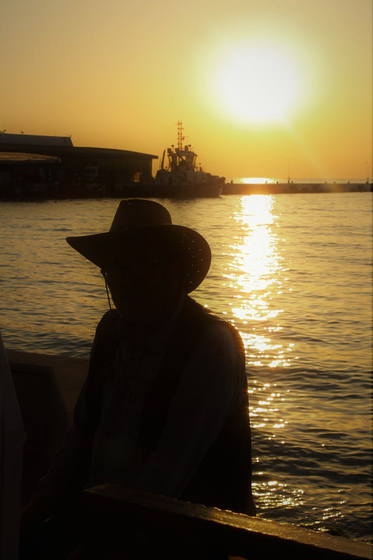 Person Silhouette On Sea Harbor