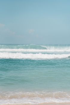 Peaceful seascape featuring gentle ocean waves under a clear blue sky, perfect for relaxation.