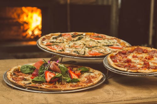 Free Shallow Focus Photography of Several Pizzas Stock Photo