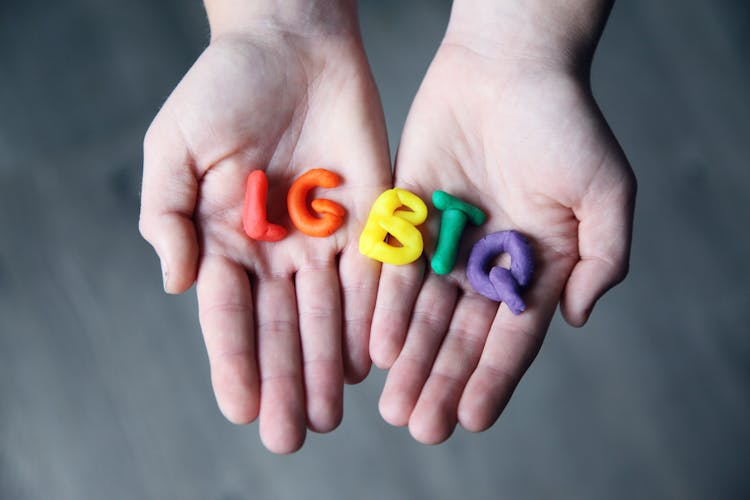 Close-Up Photo Of LGBTQ Letters On A Person's Hands