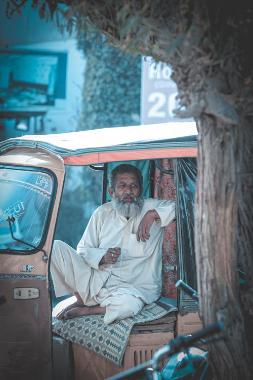 A Man Sitting in a Car 