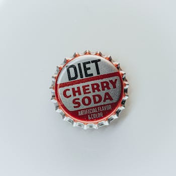 Close-up of a vintage Diet Cherry Soda bottle cap isolated on a white background.
