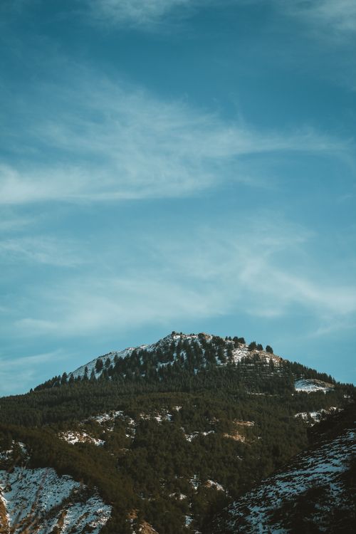 Free Scenic view of a snow-capped mountain with a vibrant blue sky, ideal for nature lovers. Stock Photo
